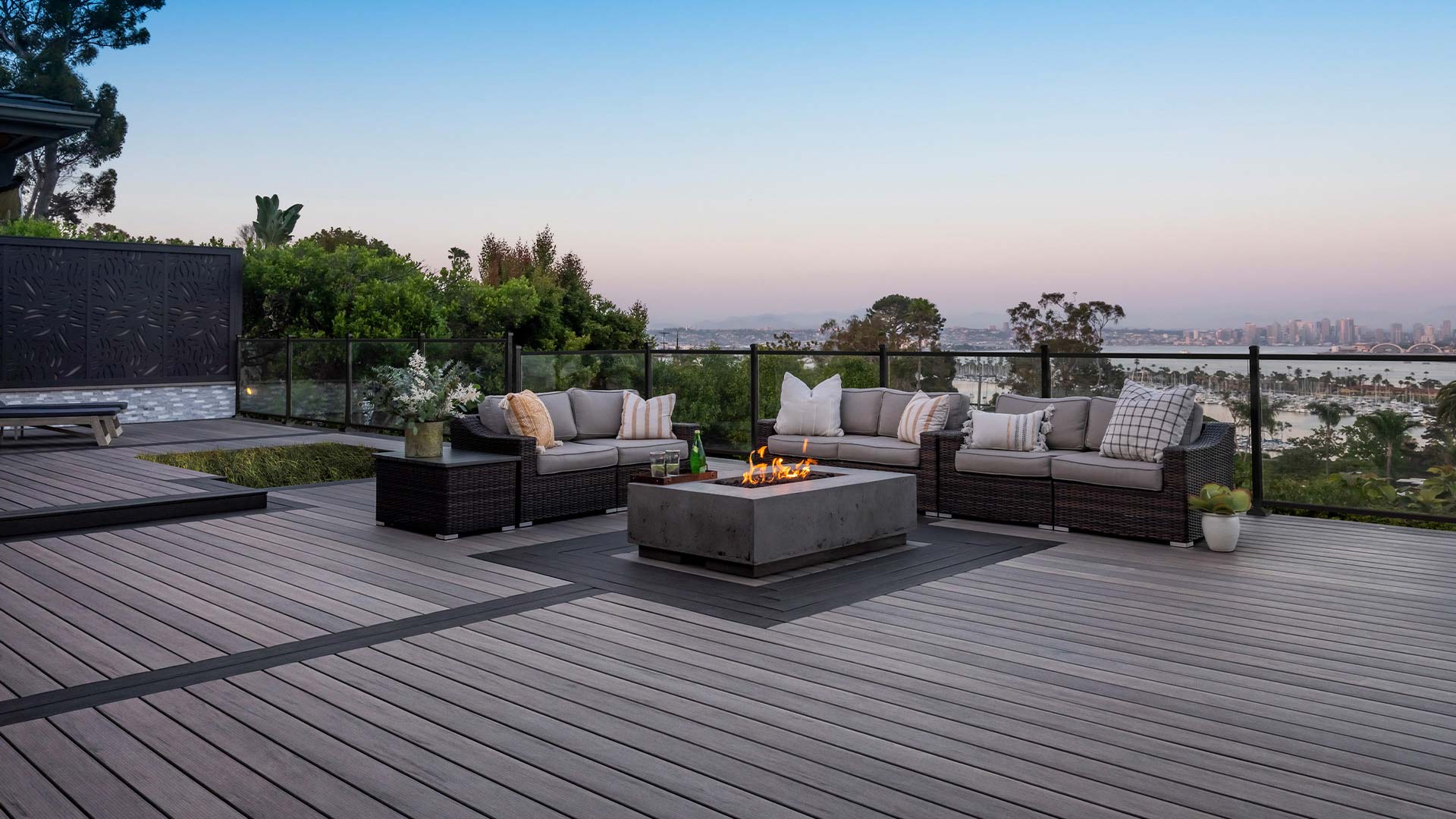 Deck with a fire pit and view of a marina below